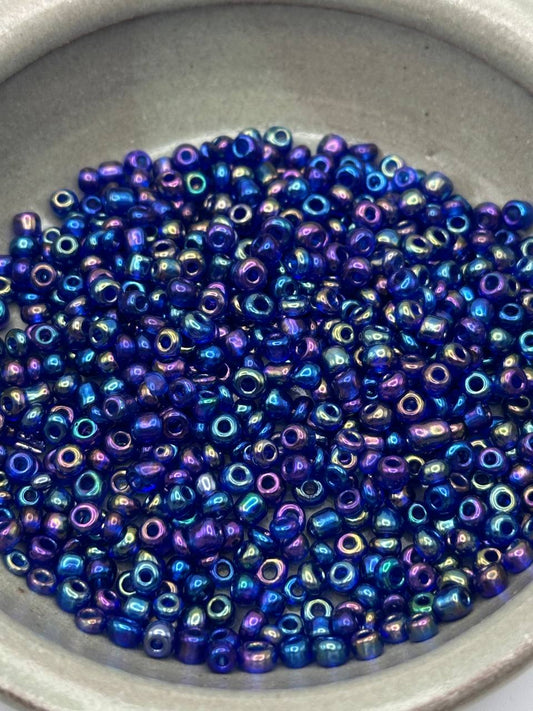 Close-up of blue and purple metallic beads in a container