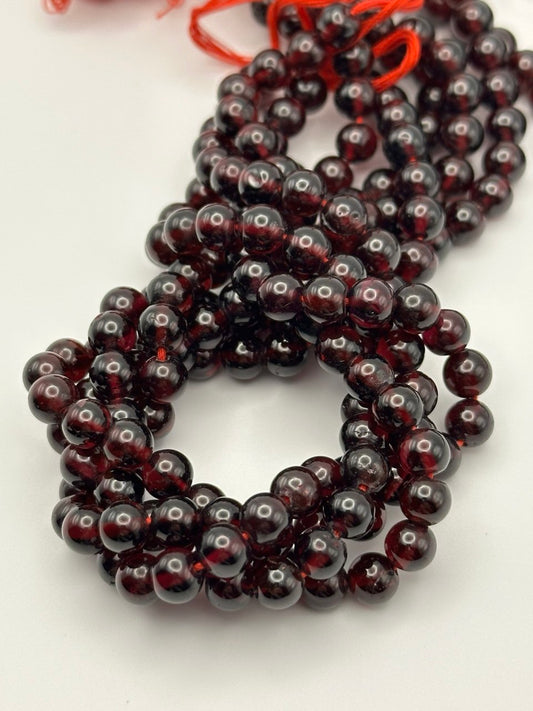 String of dark red beads on a white background