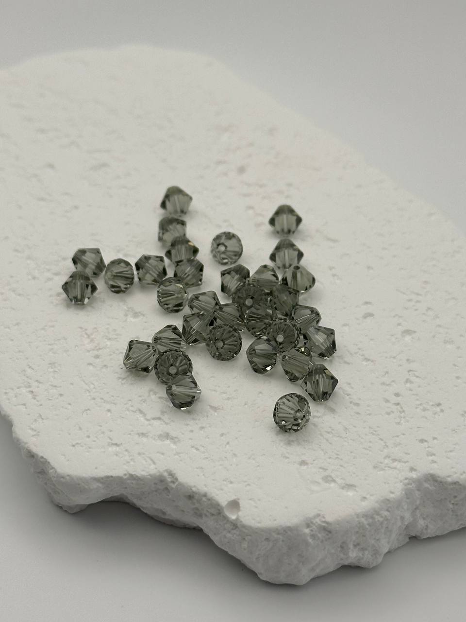 Black diamond bicone beads on white surface