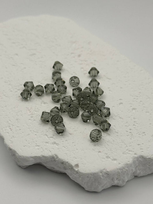 Black diamond bicone beads on white surface