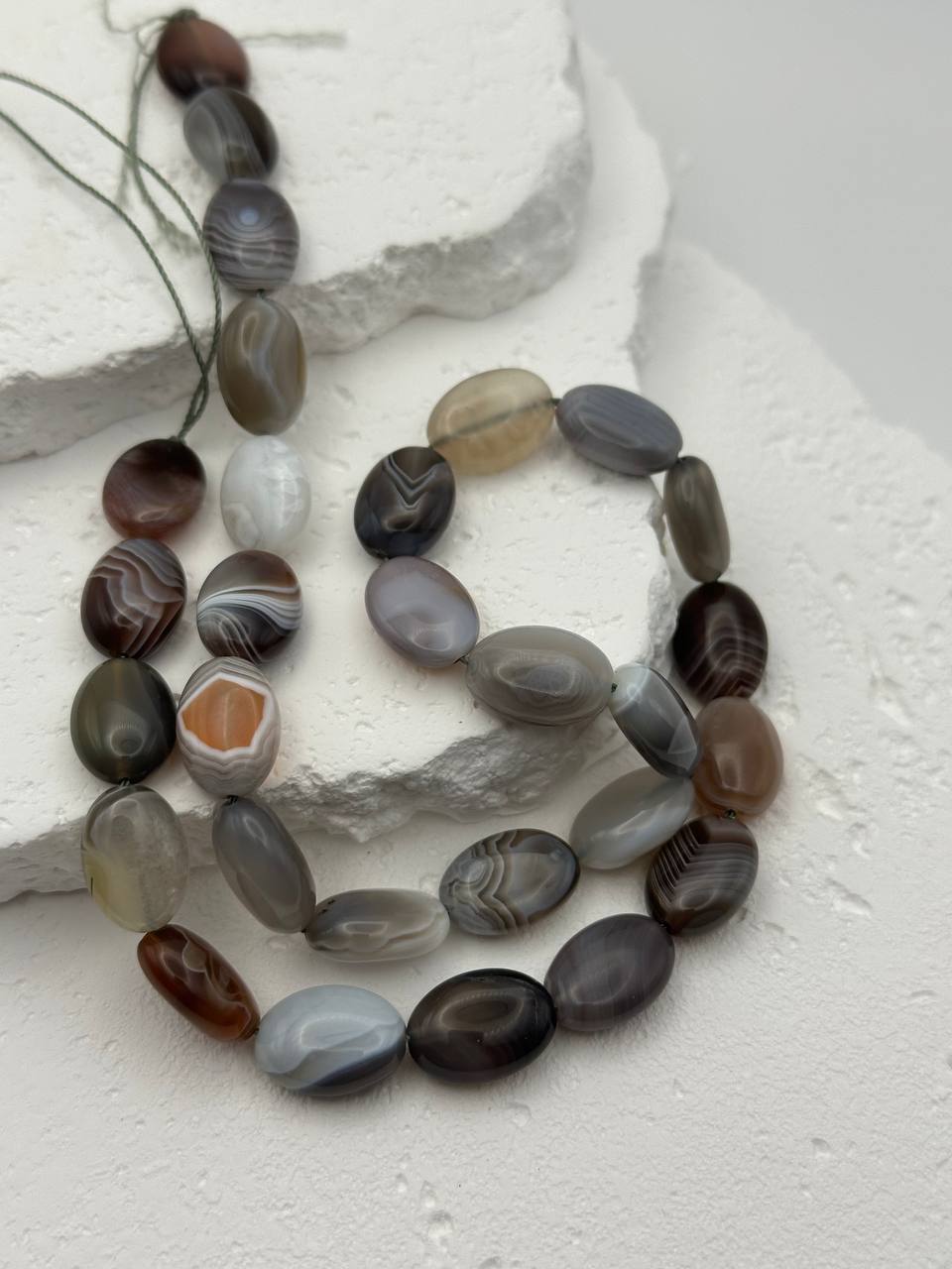 Necklace with Botswana agate beads on a textured white surface