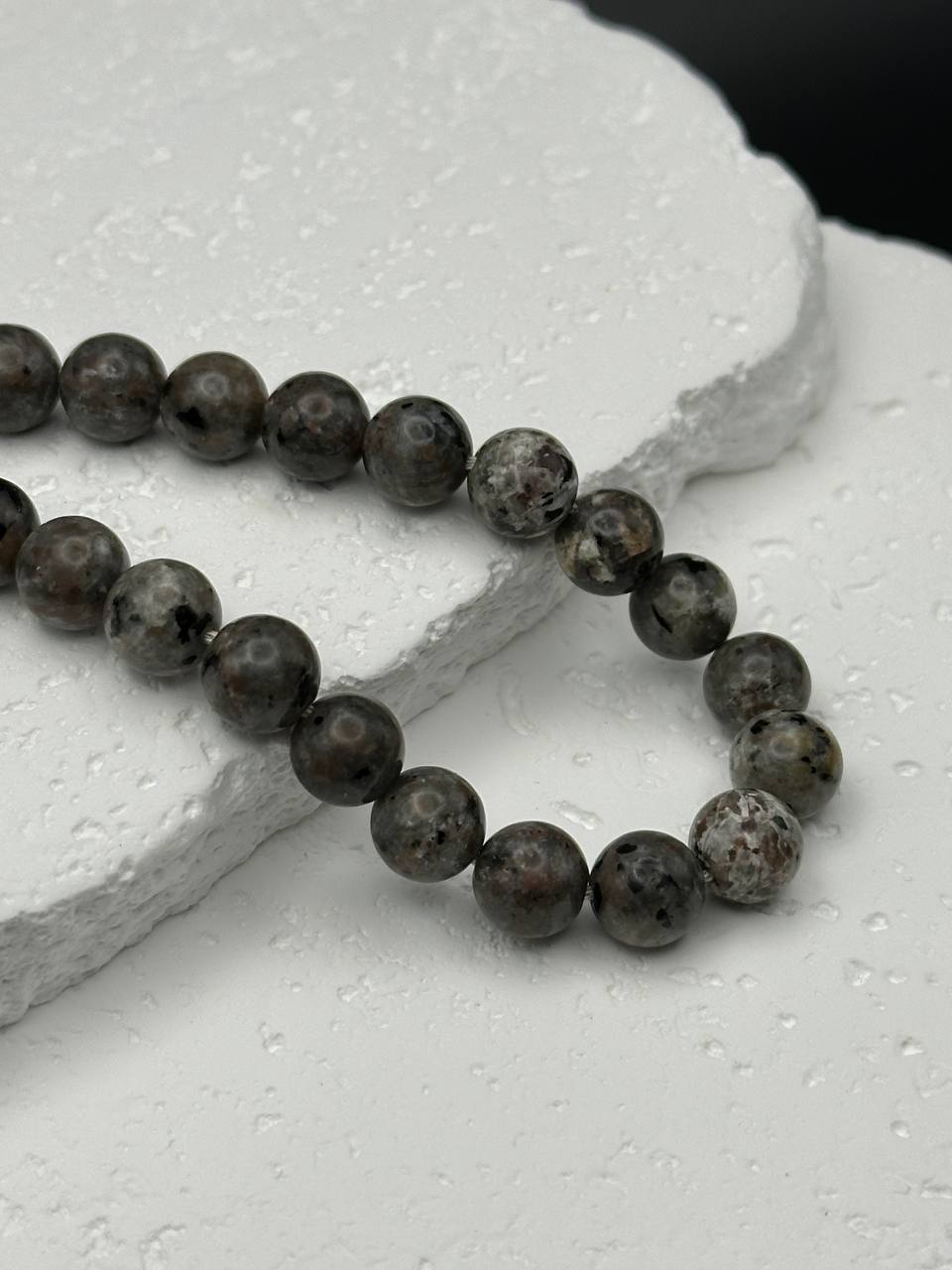 Yooperlite beads on white surface