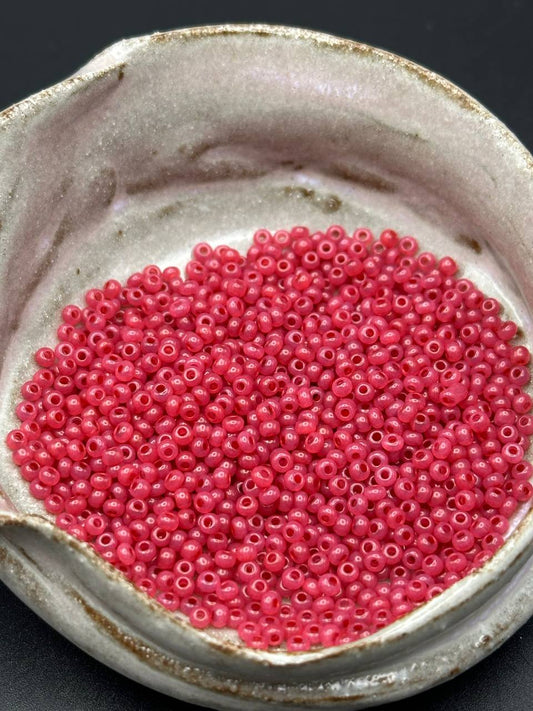 small container filled with red beads