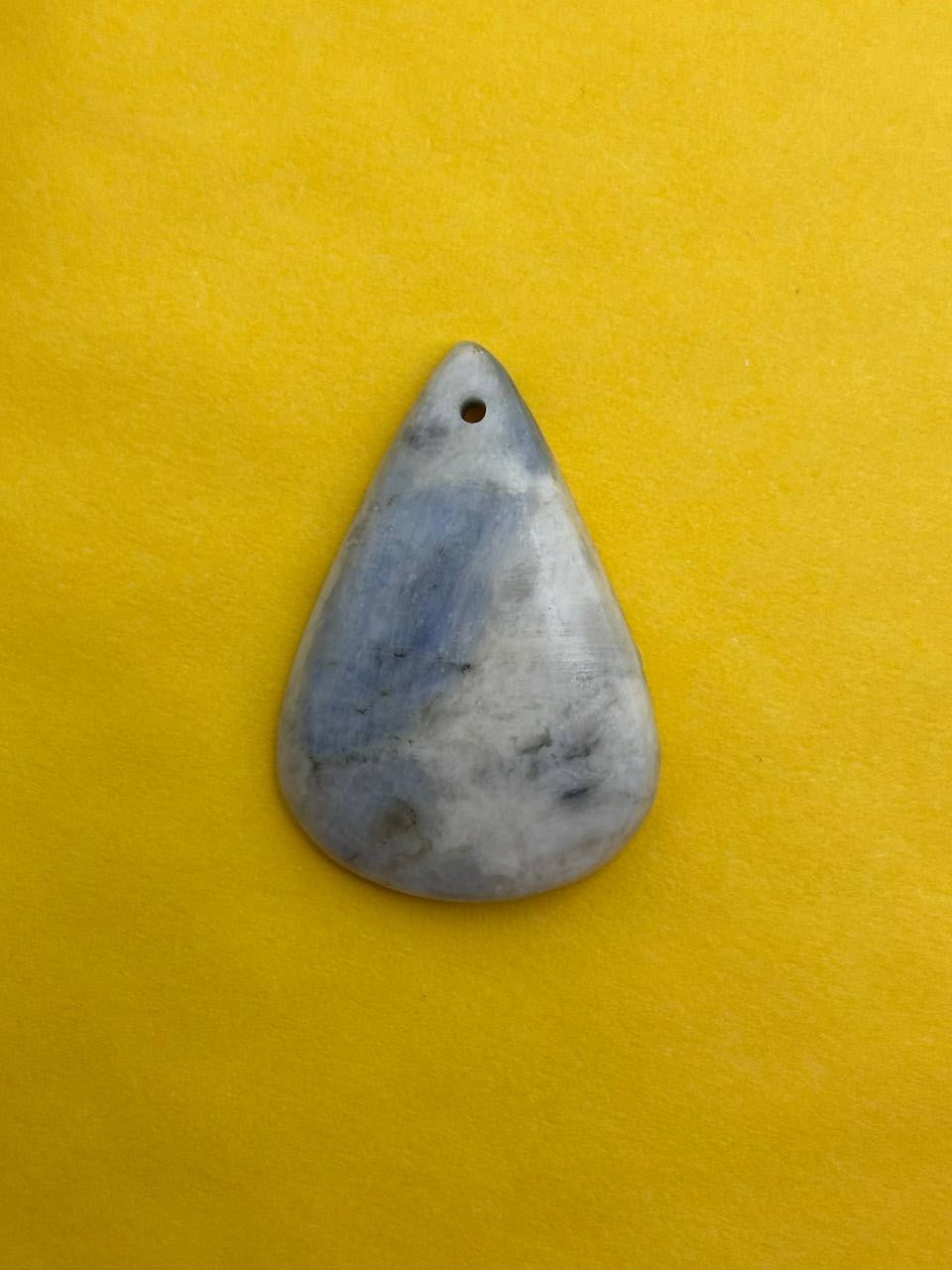 Teardrop-shaped stone on a yellow background
