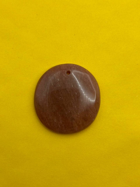 Brown circular object on a yellow background