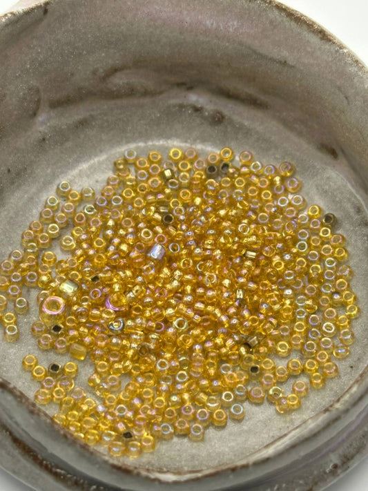 Small yellow beads on a textured surface