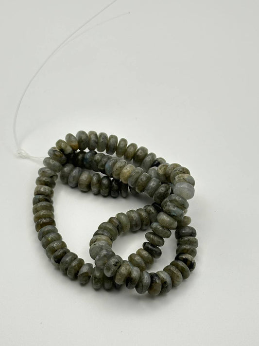 String of gray iridescent beads on a white background