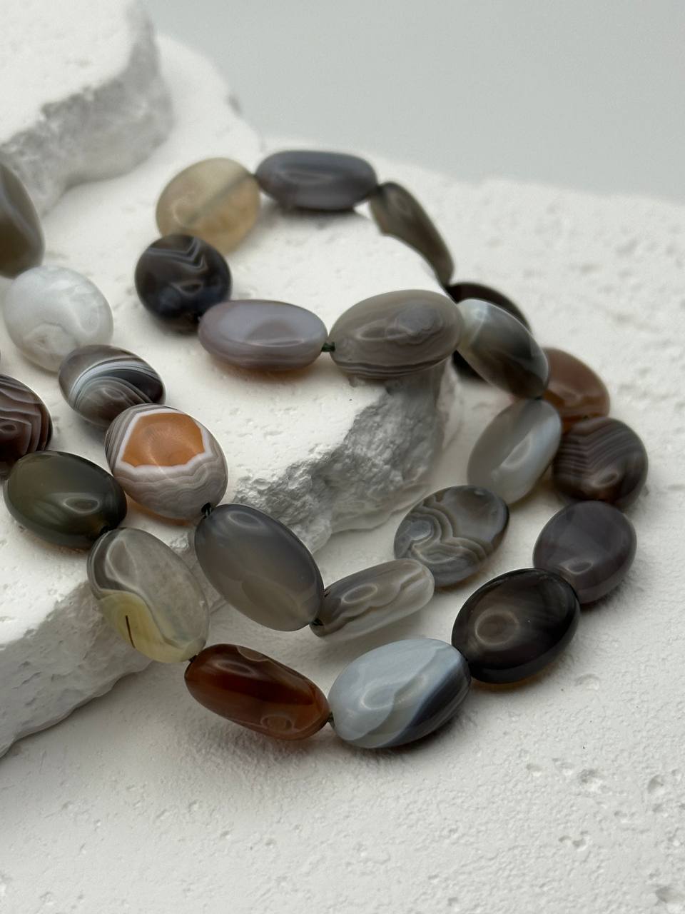 Necklace with Botswana agate beads on a textured white surface