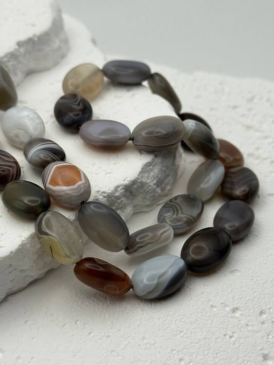 Necklace with Botswana agate beads on a textured white surface