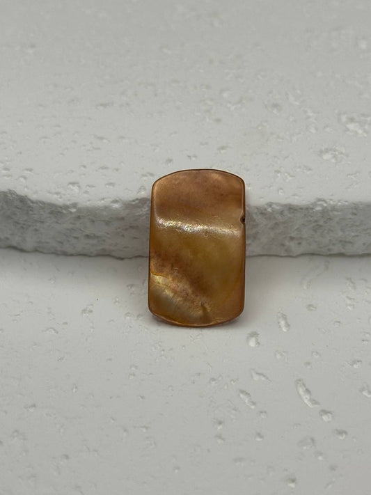 Brown pearl on a textured white surface