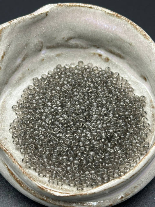 small container filled with grey beads