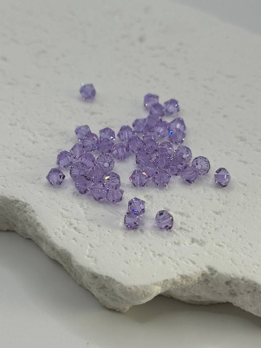 Purple beads on a textured white surface