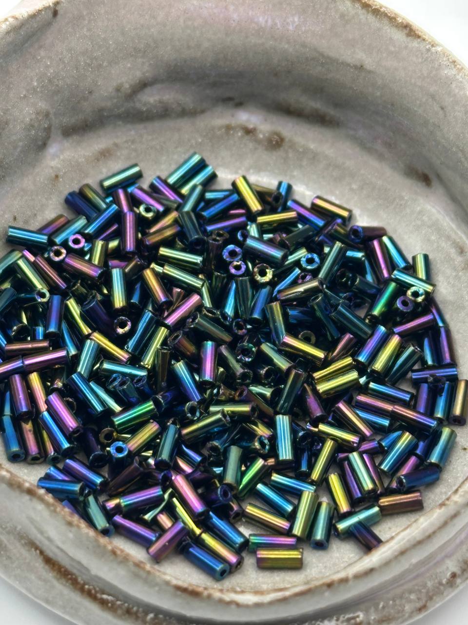 Colorful beads in a ceramic dish