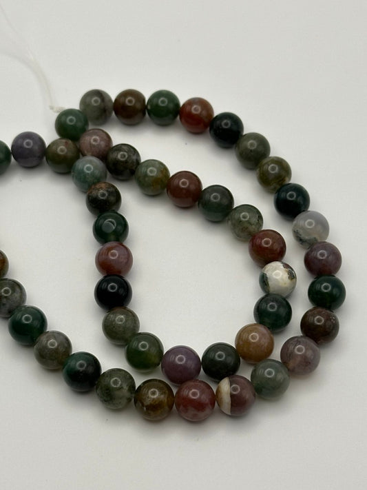 Multicolored jasper beads on white surface