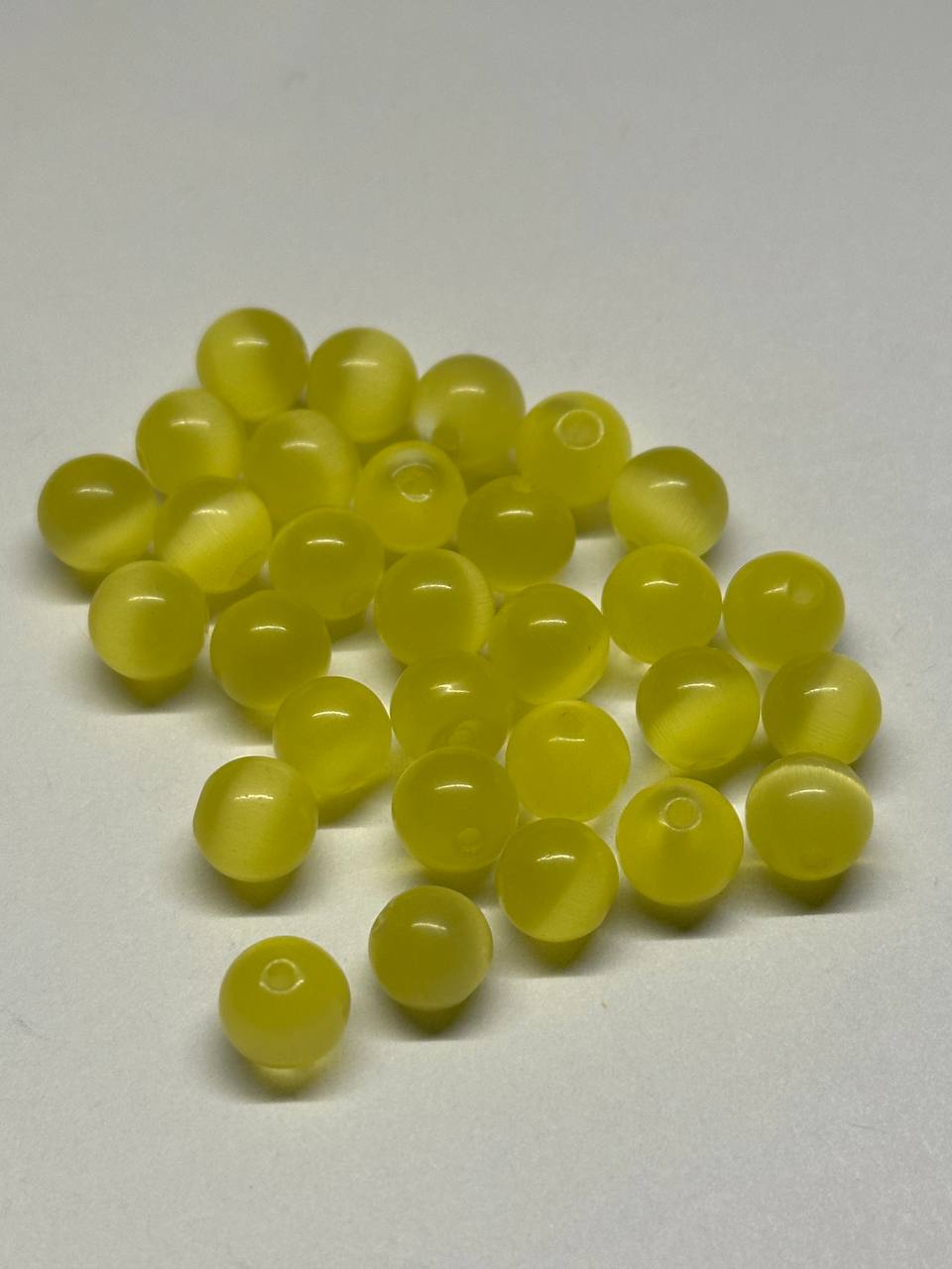 Yellow cat eye beads on a white background
