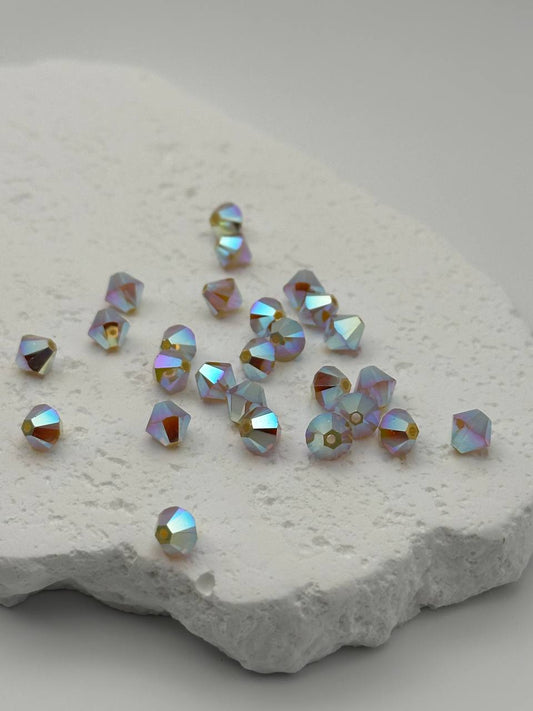 White opal shimmer bicone beads on white surface