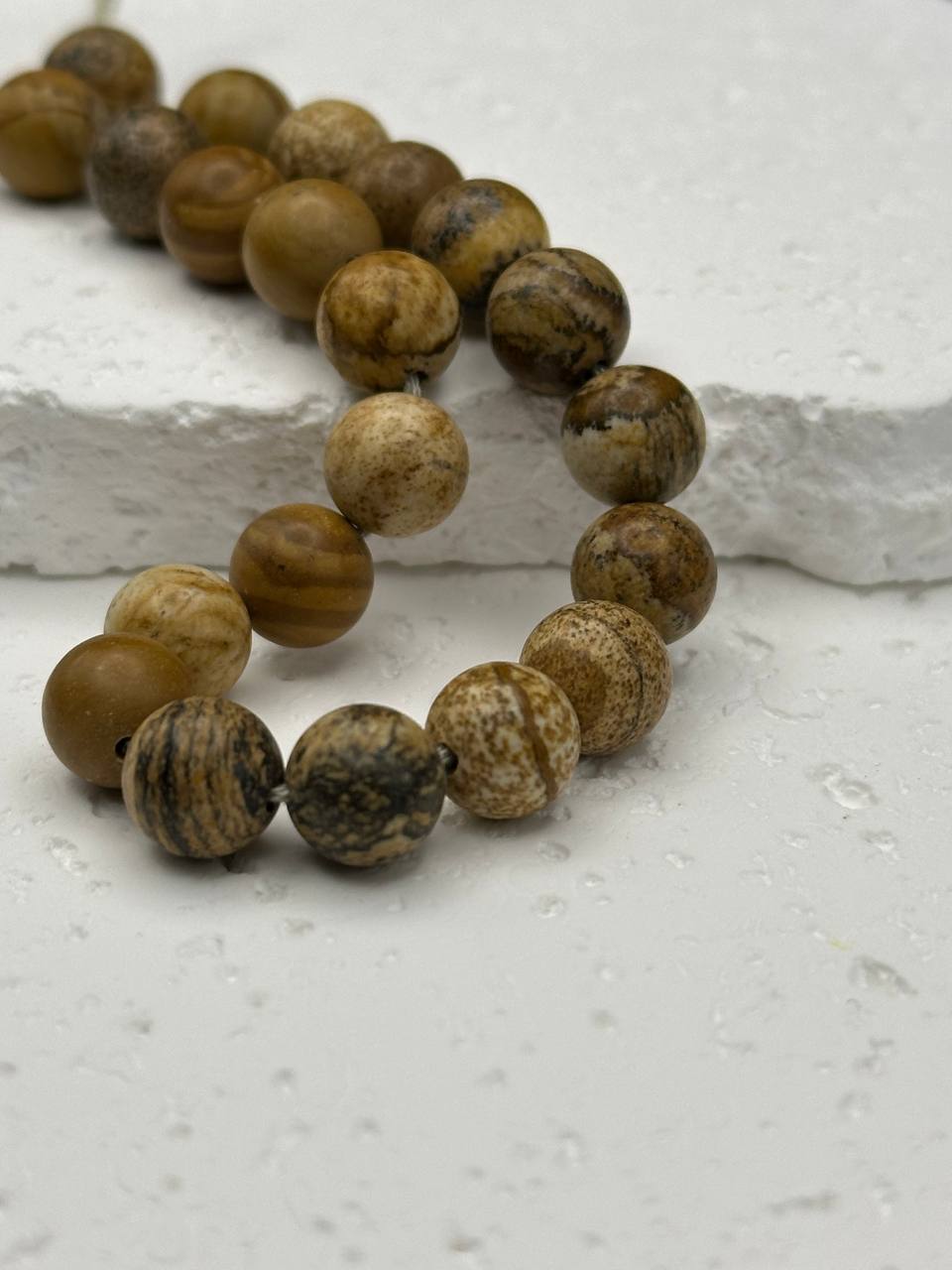 picture jasper beads on white surface