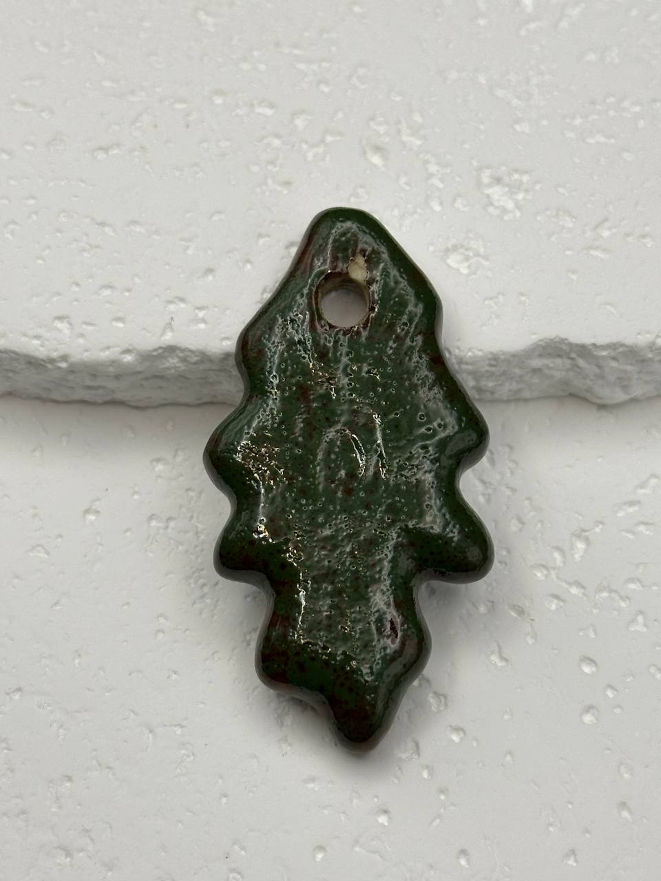 Green leaf-shaped object on a white background