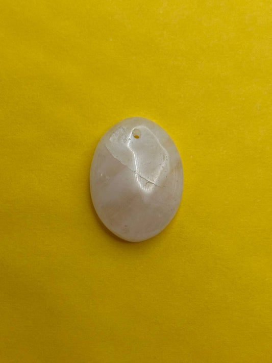 White quartz pendant on a yellow background