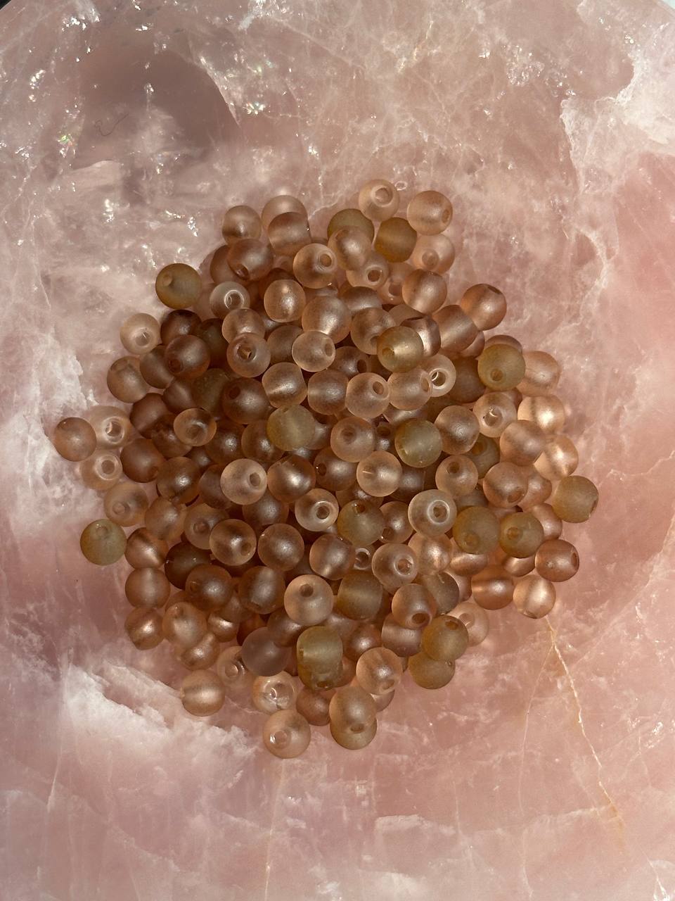 brown beads on pink surface