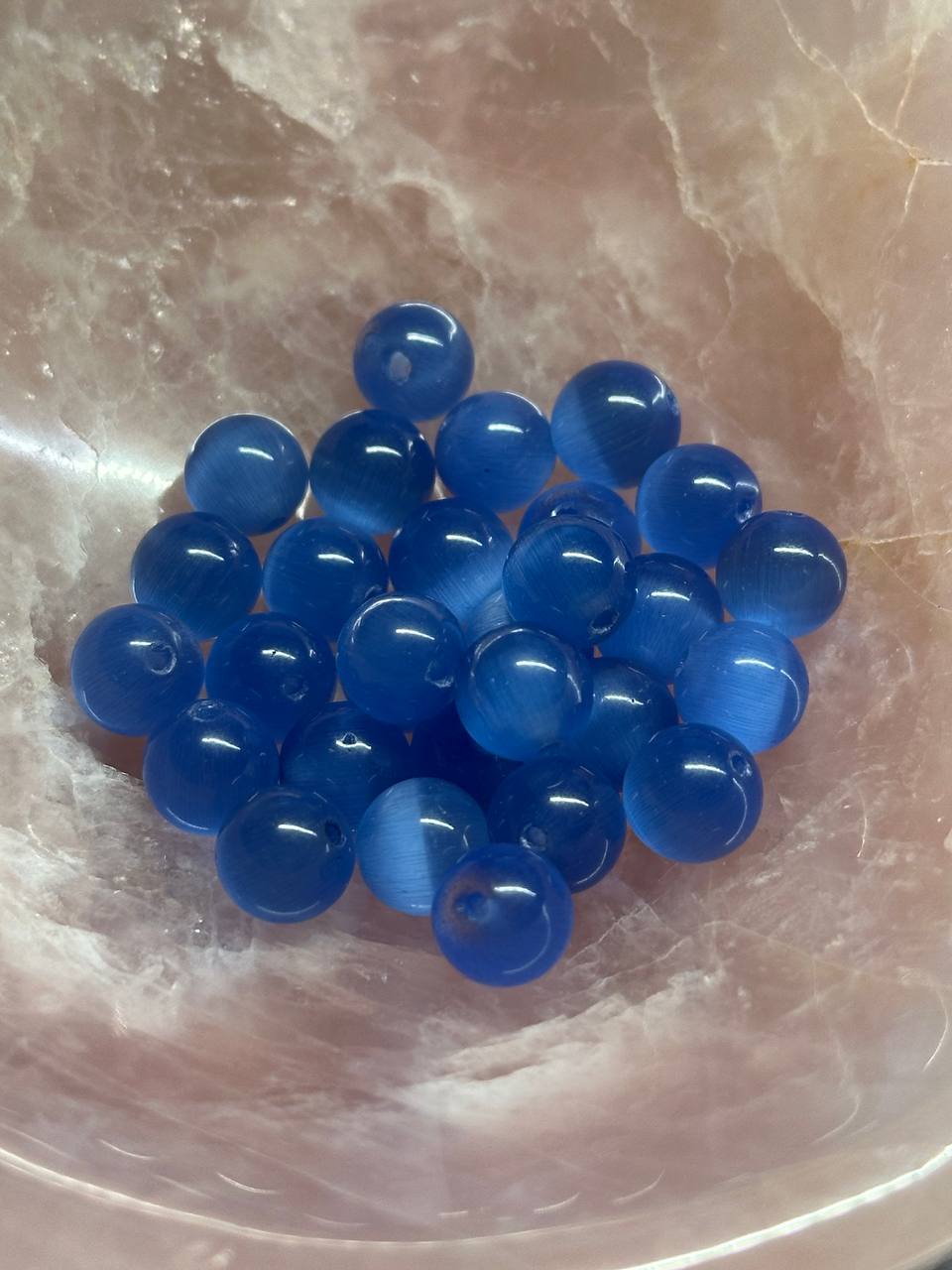 Blue beads on a marble surface