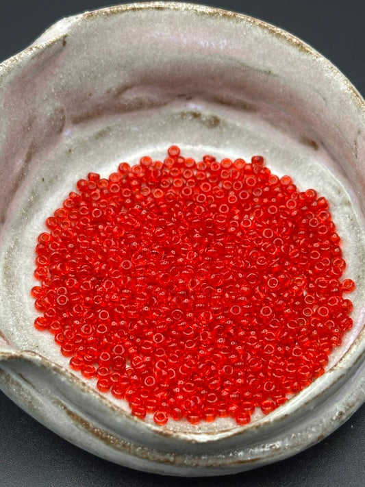 Close-up of red beads in a ceramic container