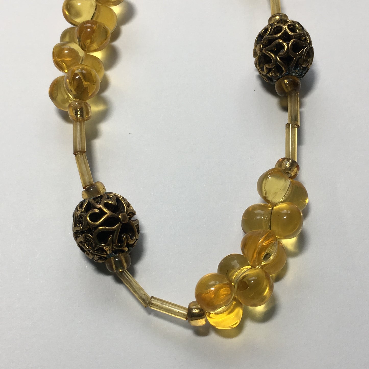 Beyond Beautiful Amber Glass 10 x 6 mm Farfalle Beads (25) with Gold Filigree Heart Design 10 mm (4) Gold Metal Beads